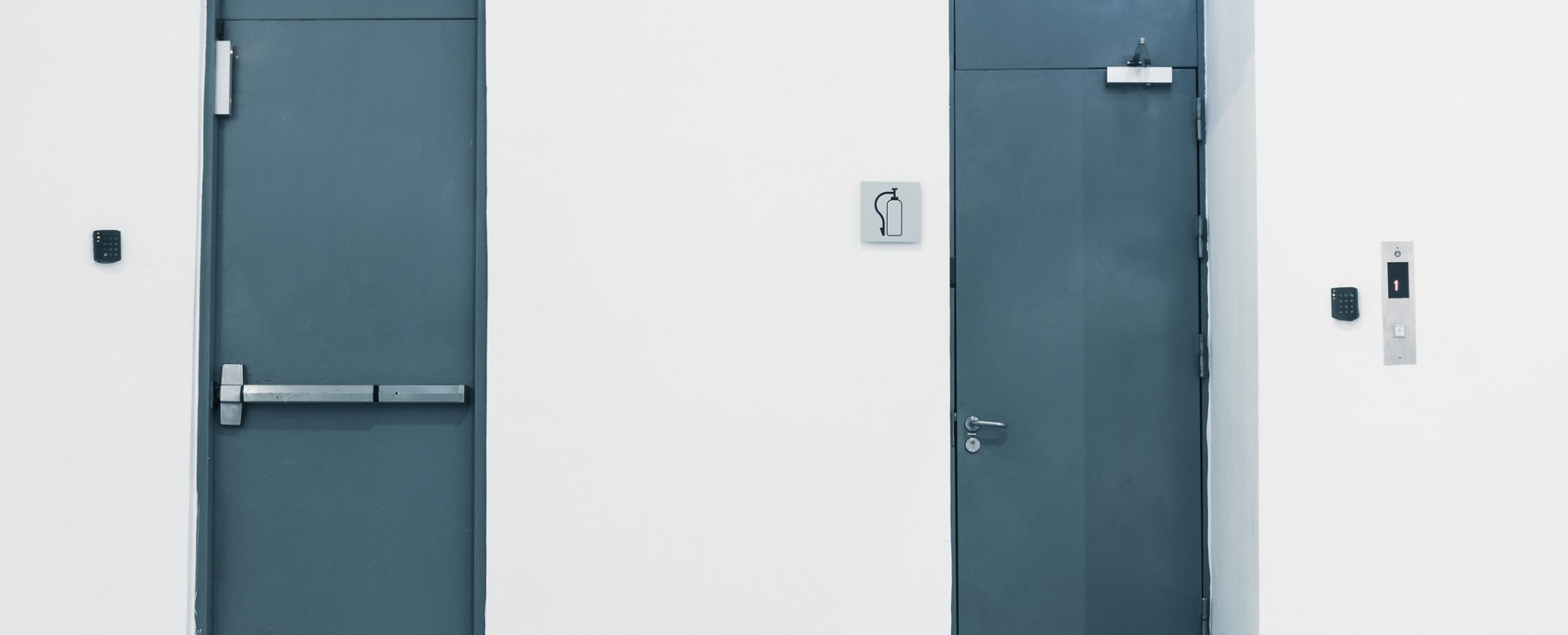 Blue steel exit and entrance doors installed with keypad code locks in close proximity for business warehouse